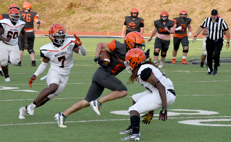 Habersham Central’s Zeke Whittington jukes two Hart County defenders during the spring game on May 20. MATTHEW OSBORNE/Staff