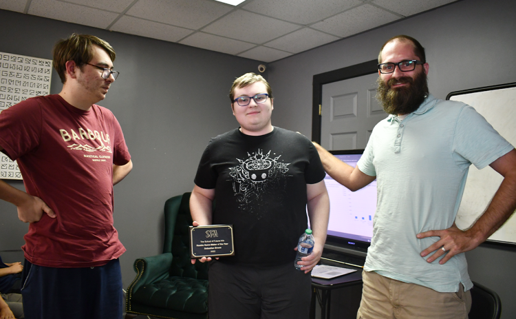 Owen Chitwood (left), last year’s Rookie Gamemaker of the Year, looks on as Sebastian Brown (center) receives the  2022 award from School of Future Arts Headmaster Justin Freeman. BRIAN WELLMEIER/Staff