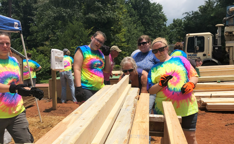 One of the teams from last year's Habitat Women Build inspect lumber before beginning work. NANETTE BAUGHMAN/Submitted