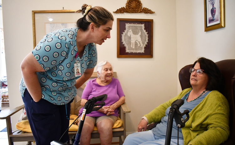 Elaina Ramirez interacts with Habersham Retreat resident Rebecca Carpenter as new resident Sarah Florence looks on. BRIAN  WELLMEIER/Staff
