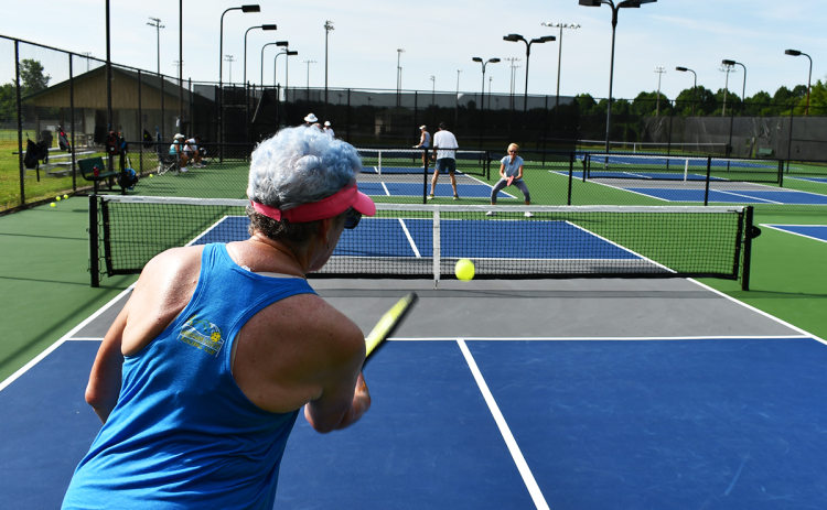 Kim Perry serves to Denise Ralph during pickleball action Monday morning in Clarkesville. MATTHEW OSBORNE/Staff