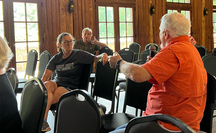 Residents Dennis Burkhalter and Jimmy Dean discuss the issue of a proposed Roads & Bridges SPLOST at Tuesday’s town hall. BRIAN WELLMEIER/Staff