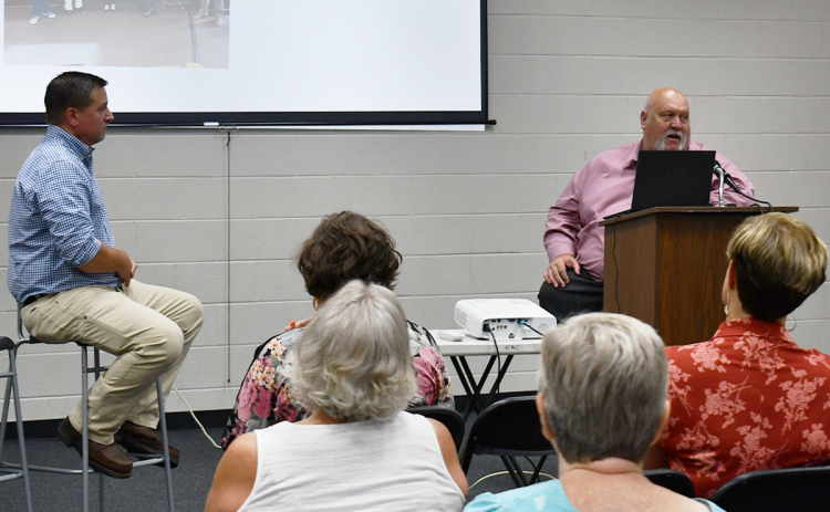 Commissioners Ty Akins and Bruce Palmer discuss economic development with the public at Wednesday’s town hall. BRIAN WELLMEIER/Staff