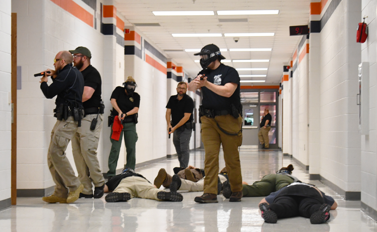 Deputies clear the hallway at Habersham Central during active shooter drill Thursday. BRIAN WELLMEIER/Staff