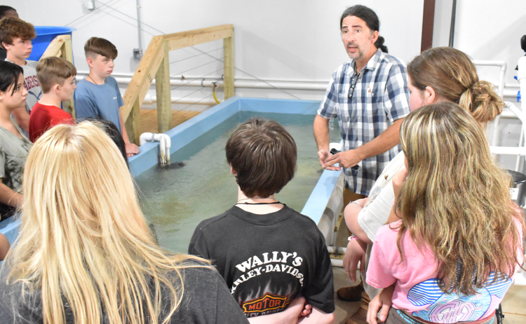 North Georgia Technical College Environmental Technology Instructor Duncan Hughes talks to a group of eighth-graders from North Habersham during their tour of the department on their “Color Tour.” AMARIS E. RODRIGUEZ/Staff