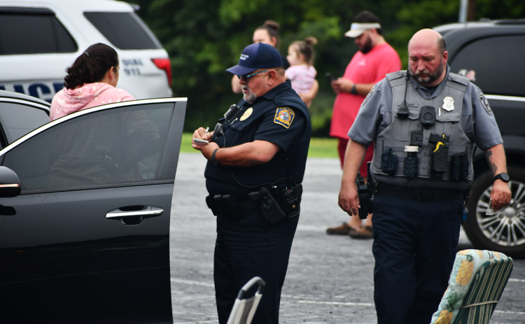 Cornelia Police interviews Mary Leigh Sheriff-Welborn (left) at the scene of a Sept. 3 shooting. MATTHEW OSBORNE/Staff