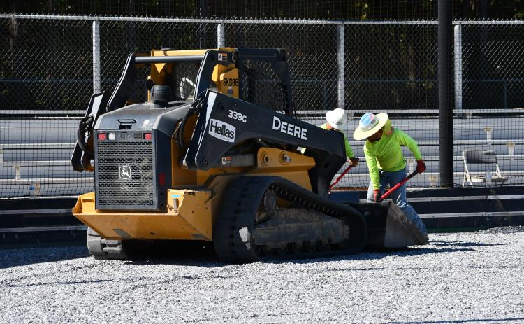 Workers from Hellas Sports Construction get the field ready for the laying of artificial turf at Raider Park in Demorest. MATTHEW OSBORNE/Staff