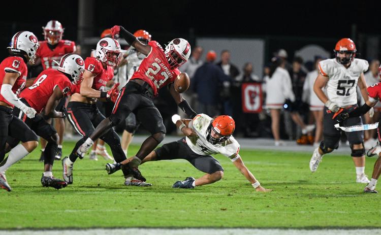 Gainesville’s Carmelo Byrd (23) rips the ball out from the grasp of Habersham Central’s Carson Parker during Friday night’s game at City Park in Gainesville. TOM ASKEW/Special