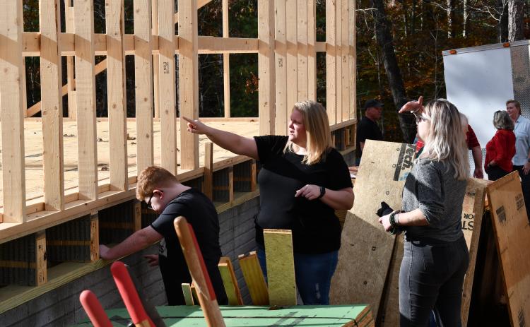Jennifer Payne and her son Caleb show friends how things are looking for their future home in Demorest. MATTHEW OSBORNE/Staff