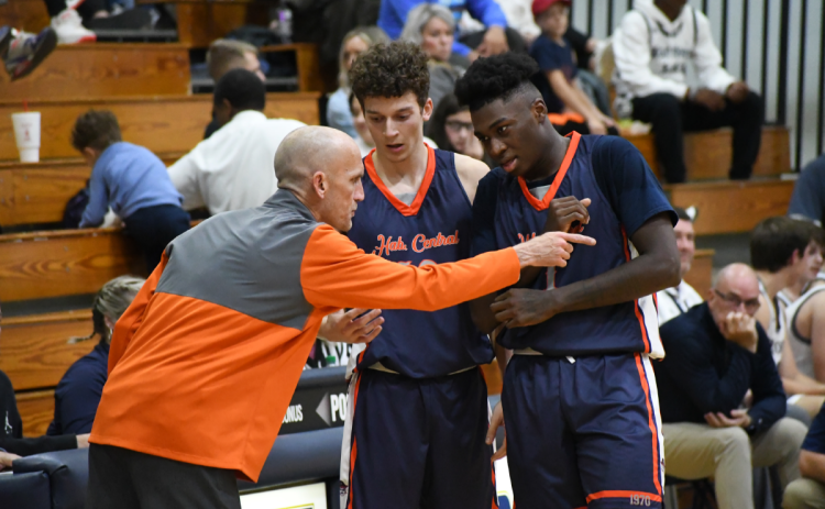 Raiders coach Tommy Yancey instructs Cole Gary and Bryce Pittman during the season opener. CODY ROGERS/Special