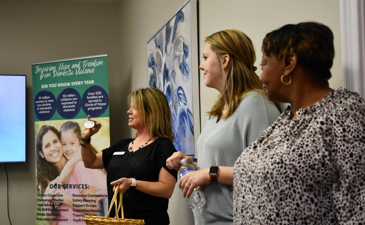 Linda Shadburn, alongside volunteers Chelsea Thomas and Gwen Wiley, presents a Circle of Hope volunteer button as a symbol of recognition for all the work their volunteers do. FILE