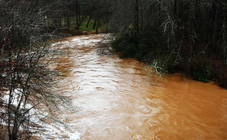 The Soque River rushes near Stribling Memorial Bridge on Habersham Mill Road early Tuesday afternoon. JOHN DILLS/Staff
