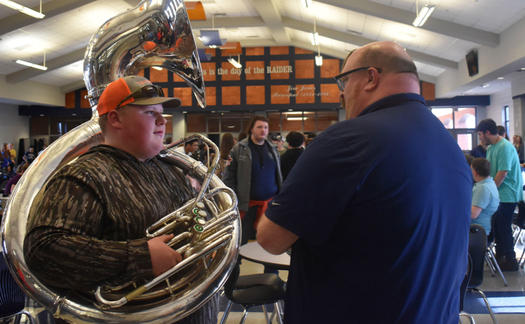 Ryan Dukes speaks with student Madison Benfield after a ceremony honoring him Wednesday at Habersham Central High School. EMMA MARTI/Staff