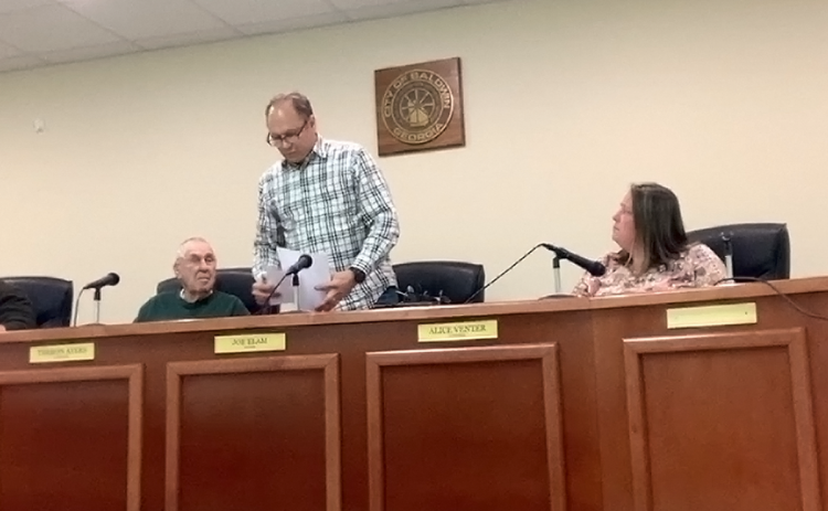 Baldwin Mayor Joe Elam gathers his papers just before leaving his post for good Tuesday night. SUBMITTED