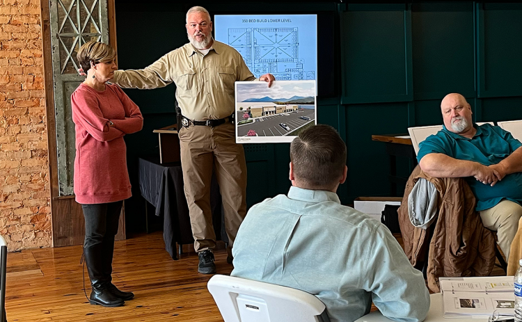 Sheriff Joey Terrell makes a presentation Friday while County Manager Alicia Vaughn (left), Commissioner Bruce Palmer (right) and Chairman Ty Akins listen. JOHN DILLS/Staff