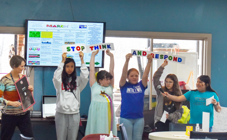 Demorest Elementary students Arielle Kinnarath, Isabella Beauchamp, Sophia Garcia, Allison Maichryc and Leslie Carranza alongside mentor Michelle Rylee teach about the STAR response of self-control, telling people to Stop, Think And Respond at the Senior Center on Tuesday.  EMMA MARTI/Staff