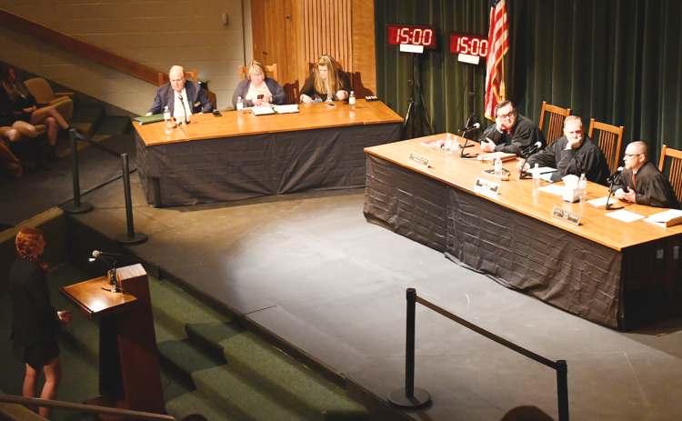 Tallulah Falls student Josie Chesser (left) asks Judges Stephen Dillard, Brian Rickman, and Trea Pipkin a question after the court’s case on Tuesday. JOHN DILLS/Staff