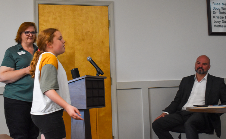 Clare Rutter, who won first place in the Performing Arts Vocal category at Rock Eagle’s Project Achievement event in February, performs the song “Almost There” from the Disney movie, “The Princess and the Frog” as Renee Smagur, Habersham County 4-H Program Assistant and Superintendent Matthew Cooper listen. EMMA MARTI/Staff