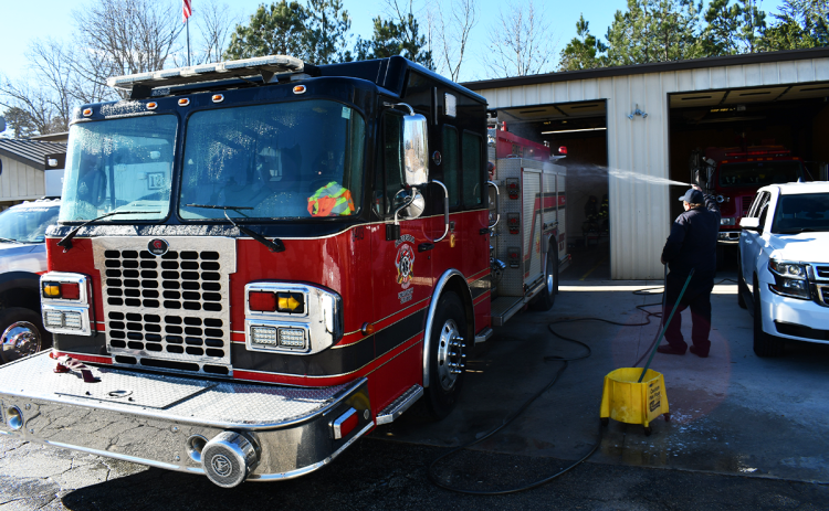 Habersham County firefighter David Thompson washes down one of the trucks at Firehouse 12 earlier this year. Habersham County took a second shot at the SAFER grant to add much-needed fire personnel, this time using grant writer Lauren Long instead of a third-party contractor that did not win the grant last year. JOHN DILLS/Staff