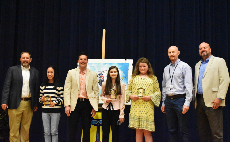 HCHS Principal Dr. Jonathan Stribling, 10th-grade winner Phoebe Warren, NGA Principal David Leenman, 9th-grade winner Kenzielynn Bodiford, 6th-grade winner Contessa Champlin, NHMS Principal Dr. Adam Bagwell and Superintendent Matthew Cooper pose together after the ceremony. EMMA MARTI/Staff