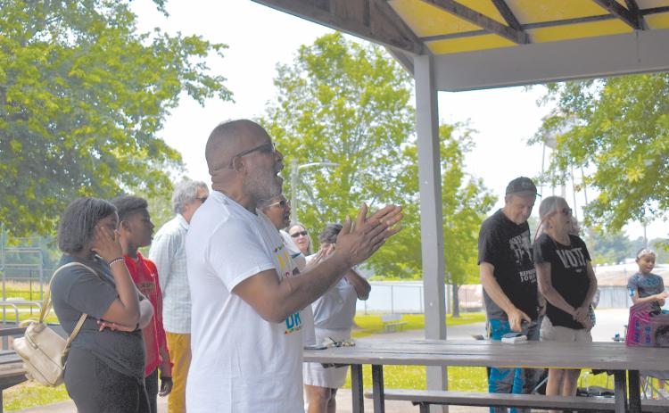 Shady Grove Missionary Baptist Church Pastor Ernest Burns sings along to the Black National Anthem during Saturday’s festivities. EMMA MARTI/Staff