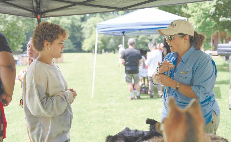 Kyra Purdee (left) speaks with Georgia DNR Interpretive Ranger Kathy Church about the Eastern Garter Snake, among other snakes, which were brought out for the Soque River Festival on June 24. ZACH TAYLOR/Special