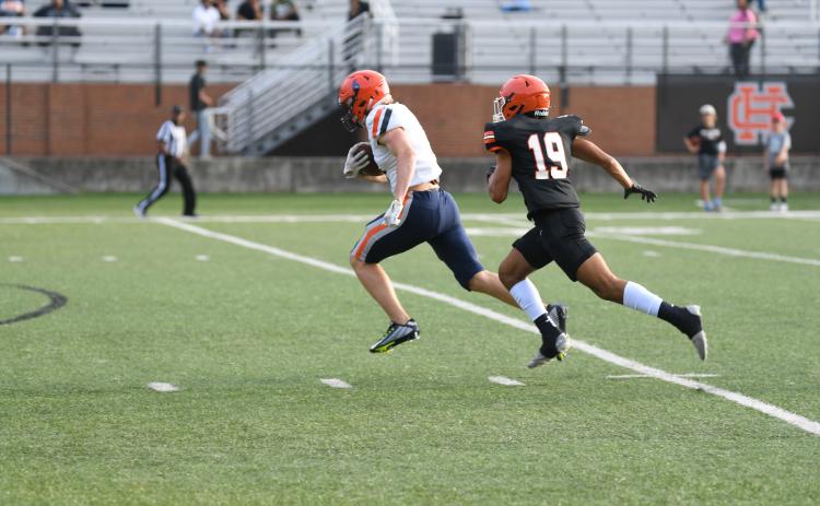Habersham Central’s Jonah Wilson runs away from a Hart County defender during the spring game. The fall preseason game is just nine days away.  TOM ASKEW/Special