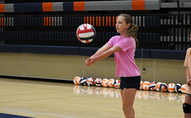 Bailey Worley bumps a ball back to instructors Thursday morning. LANG STOREY/Staff