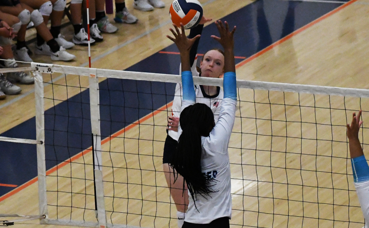 Habersham Central’s Katelynn LoBuono looks to spike the ball through the block of a Seckinger player during Thursday’s exhibition. LANG STOREY/Staff