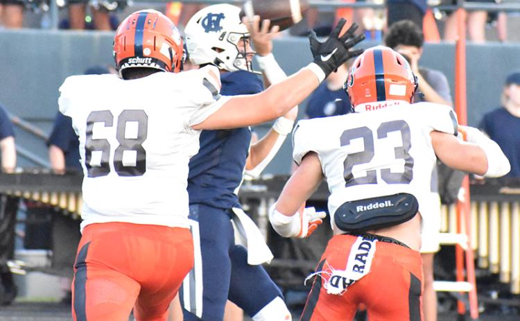 Habersham Central defenders Aidan Cianci (68) and Carter Barrett (23) chase White County quarterback Tripp Nix during the Aug. 25 game.