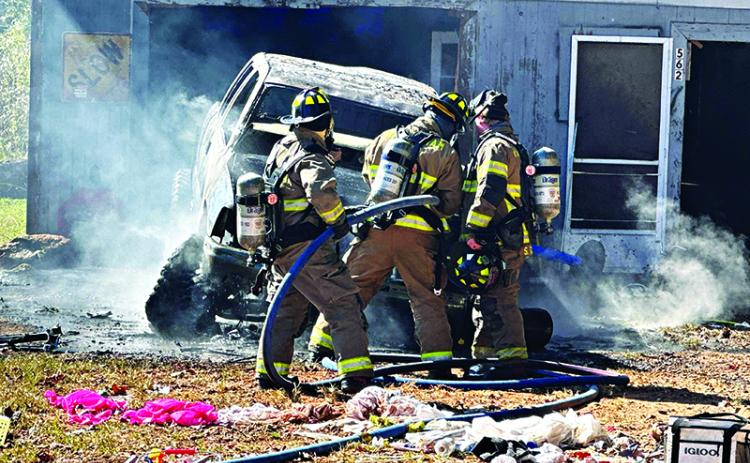 Habersham County firefighters check the engine compartment of the burning truck on Sutton Road in the Fairview community. HABERSHAM COUNTY/Submitted