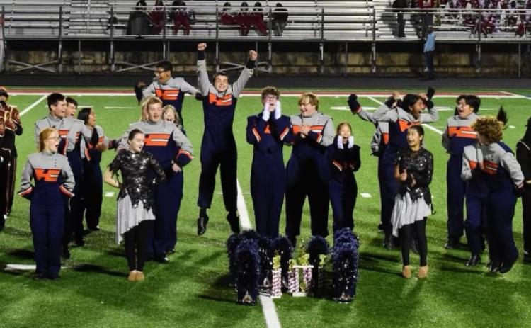 The Band of Blue celebrates their achievement. Submitted