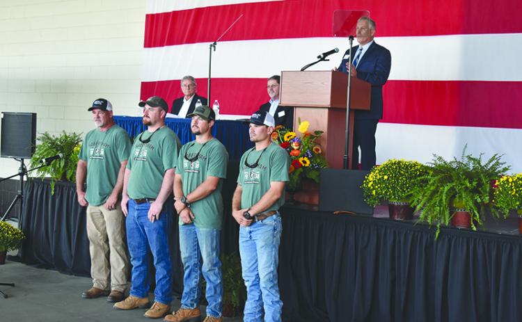 Habersham EMC and CEO Bryan Ferguson (on stage) recognized its lineman who were champions of last year’s International Lineman’s Rodeo, including coach Chris Chapman, Tucker Dyer, Robert Morris and Dillon Welborn. MATTHEW OSBORNE/Staff
