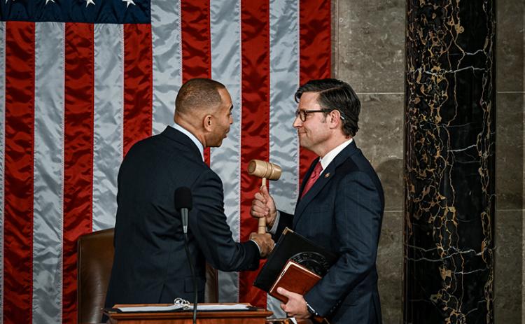 Speaker Mike Johnson is handed the gavel on Wednesday. THE NEW YORK TIMES
