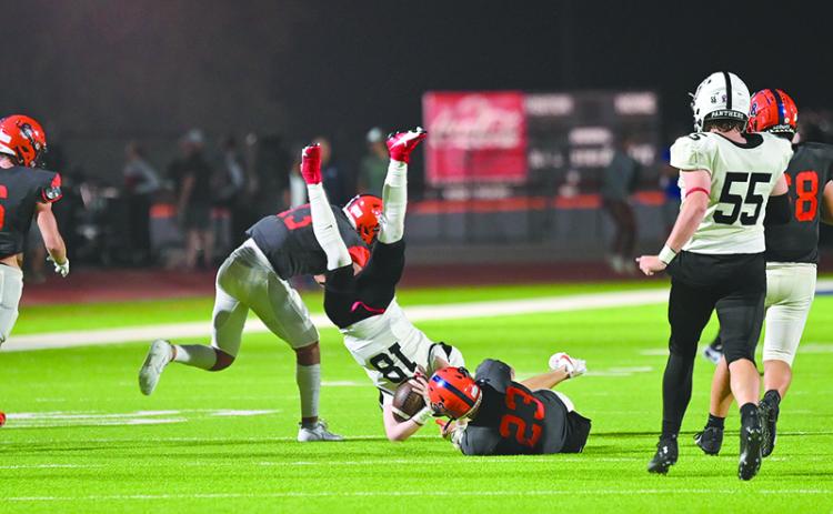 Habersham Central’s Carter Barrett (23) and Keller Green upend Jackson County’s Slade  Swierczek during their last home game. TOM ASKEW/Special