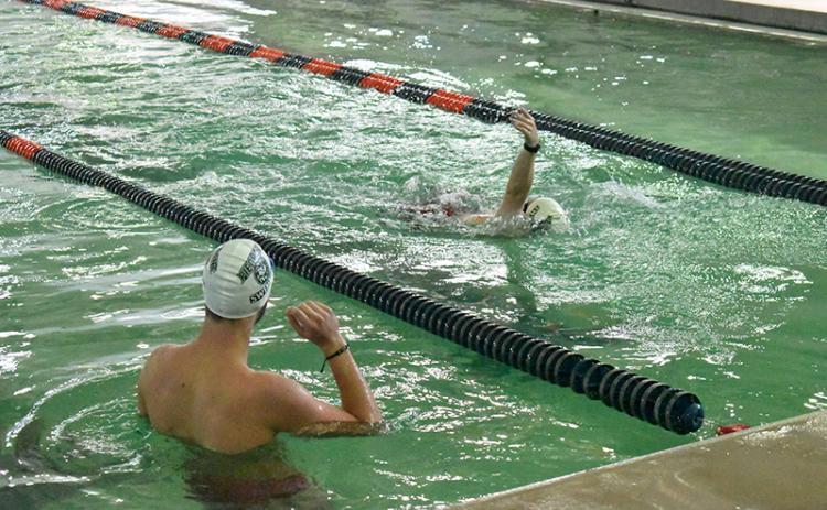 Piedmont swimmer Sam Teed looks on as teammate Will Donaldson swims laps on Monday. The pool was closed for almost two months and the repairs spilled into swim season, canceling the first home meet. Piedmont, Habersham Central and youth swimmers all use the facility for practice as well. LANG STOREY/Staff