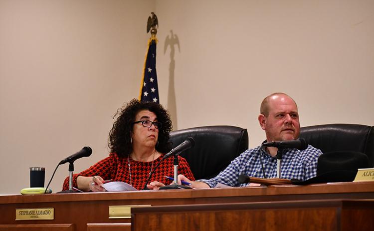 Baldwin Councilmembers Stephanie Almagno (left) and Erik Keith listen to a speaker during Monday’s meeting. JULIANNE AKERS/Staff