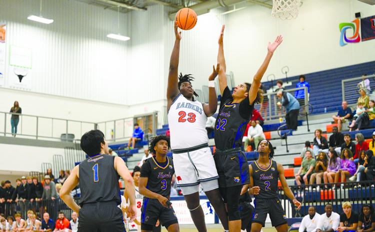 JoJo McCurry lands a hook shot over a defending Chattahoochee forward on Saturday night.  McCurry is a big part of the  Raiders’ plans to take a step forward this season. ZACH TAYLOR/Special