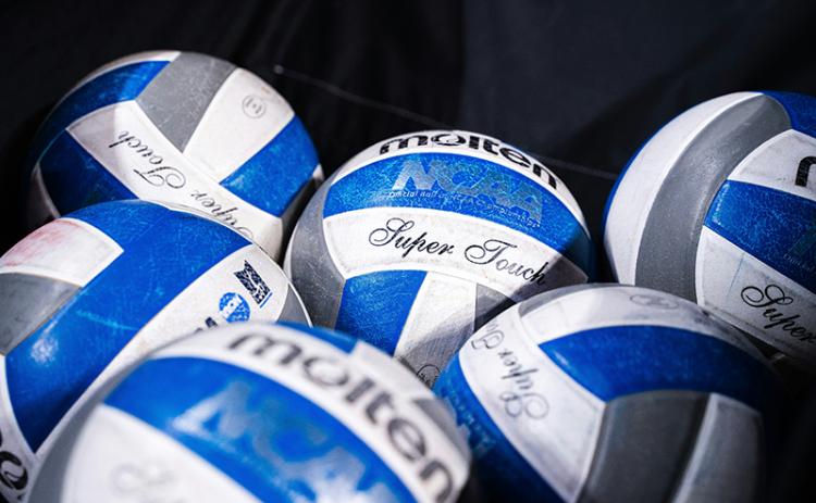 Volleyballs sit in a catch bin waiting to be used. UNSPLASH