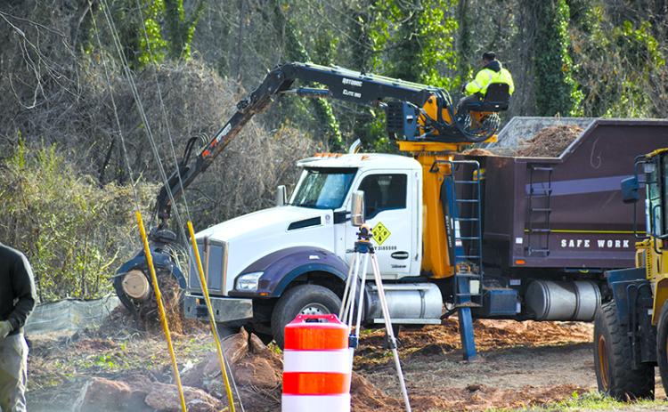 Workers undertake moving the sewer lines near the Johnny Mize Bridge in Demorest. MATTHEW OSBORNE/Staff