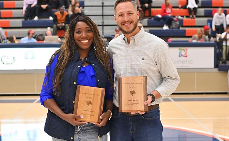 New Raider Basketball Hall of Fame inductees Sheena Trimiar and Heath Barrett meet on the court between games Friday night. TOM ASKEW/Special