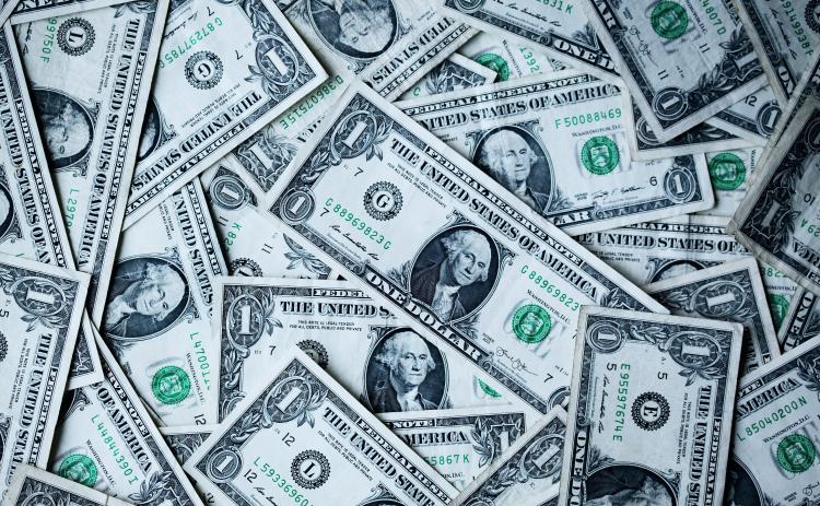 Photo of a pile of cash. Photo by Alexander Grey/Unsplash