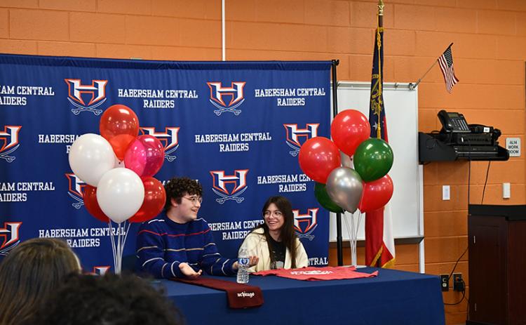 Habersham Central High School seniors Micah Zack and Kate Navarro share a laugh at Wednesday’s scholarship presentation. JULIANNE AKERS/Staff