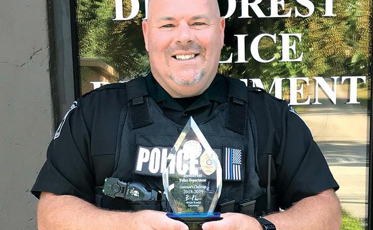 Former Demorest Police Chief Robin Krockum shows off the department’s award for best highway safety in the state in 2018-19. FILE