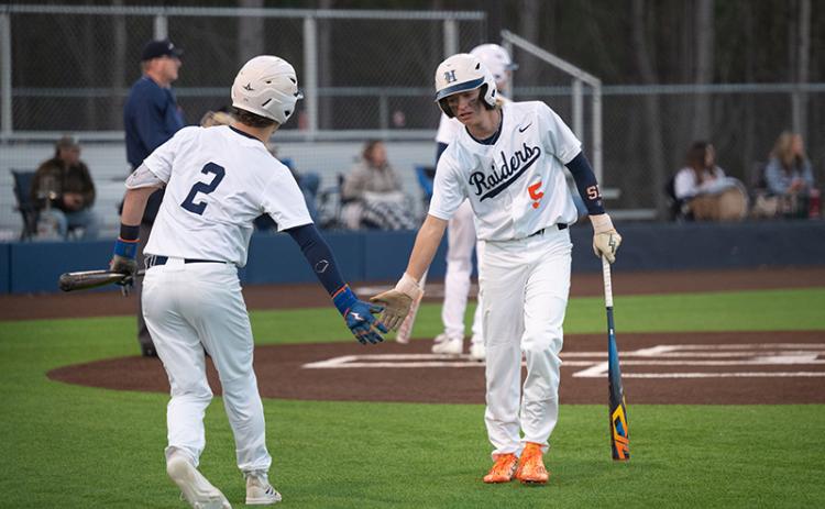 After touching home plate, Maverick Chitwood low-fives Raiders catcher Spencer Frady on the way to the dugout in an earlier win over Elbert County. ZACH TAYLOR/Special