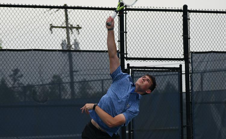 Habersham’s Josh Burris slams a serve in Wednesday’s state match against Newnan. LANG STOREY/Staff