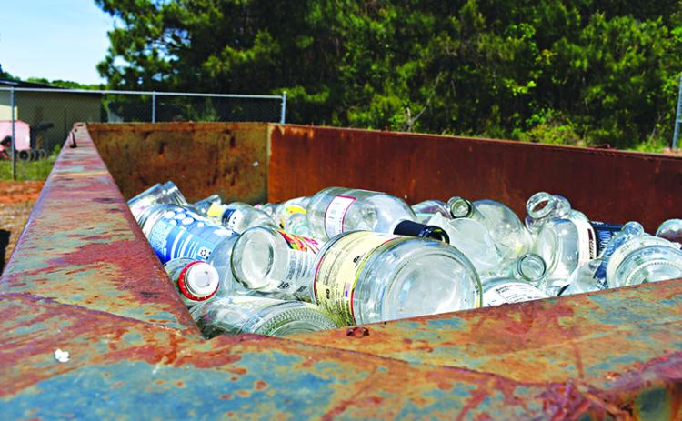 Glass bottles sit at the Cornelia Recycling Center waiting to be hauled and processed. JULIANNE AKERS/Staff