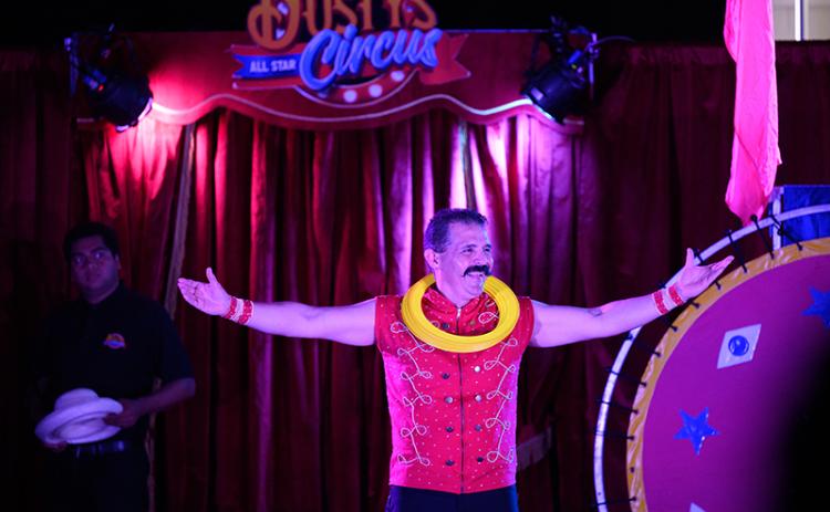 Alberto Alegria smiles to the crowd after he juggles the rings onto his neck. ZACH TAYLOR/Special