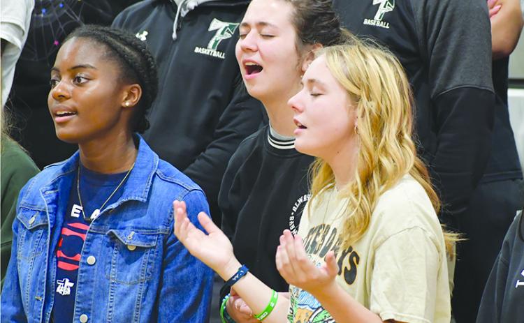 Kaylin Pickett, Caroline Smith and Lily Turpin rejoice at last year’s Fields of Faith at Tallulah Falls School. FILE