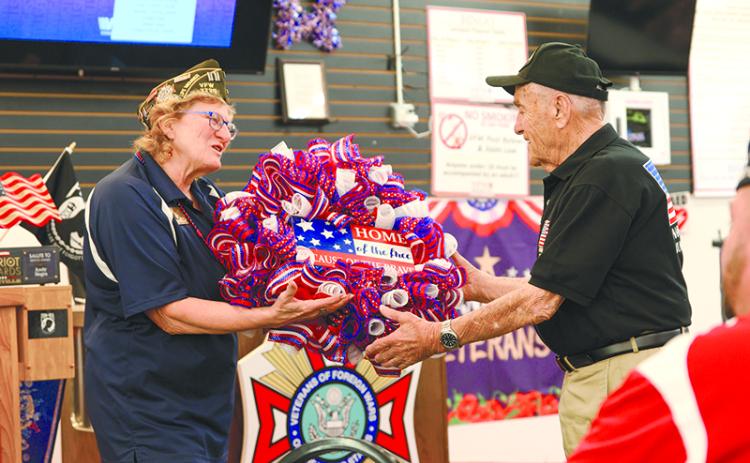VFW Post 7720 Adjutant Connie Barrow gifts Andy Negra a wreath that reads “Home of the free because of the brave.” ZACH TAYLOR/Special